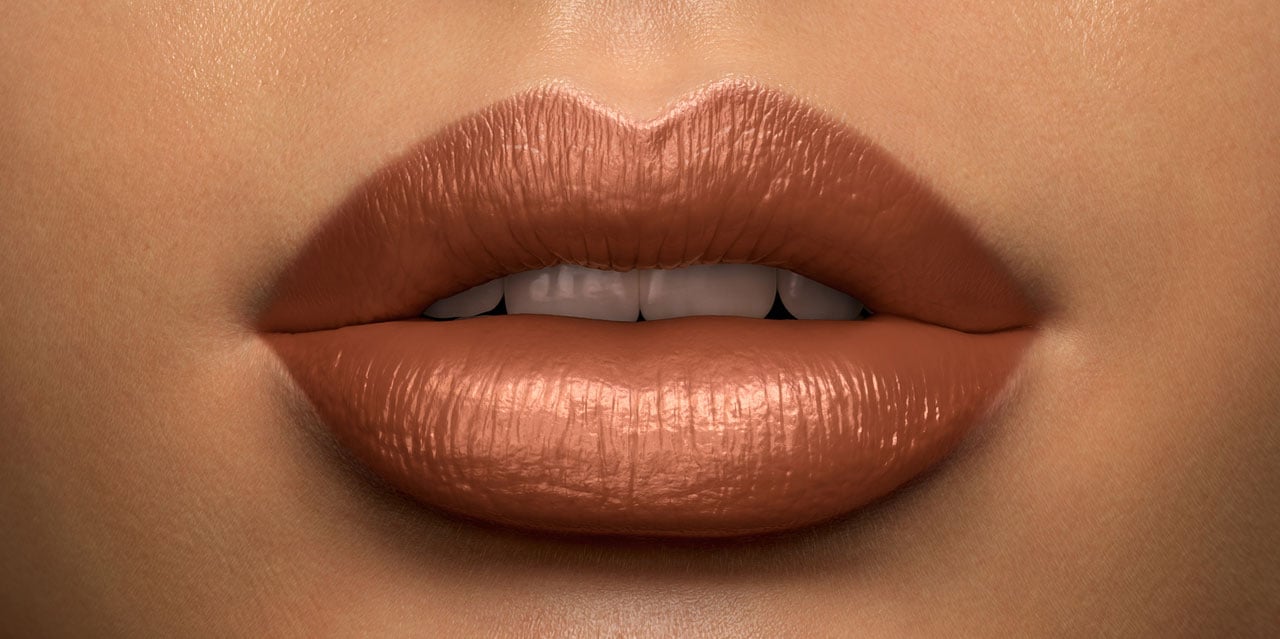 Warm golden brown lipstick shade worn on a medium skin tone 